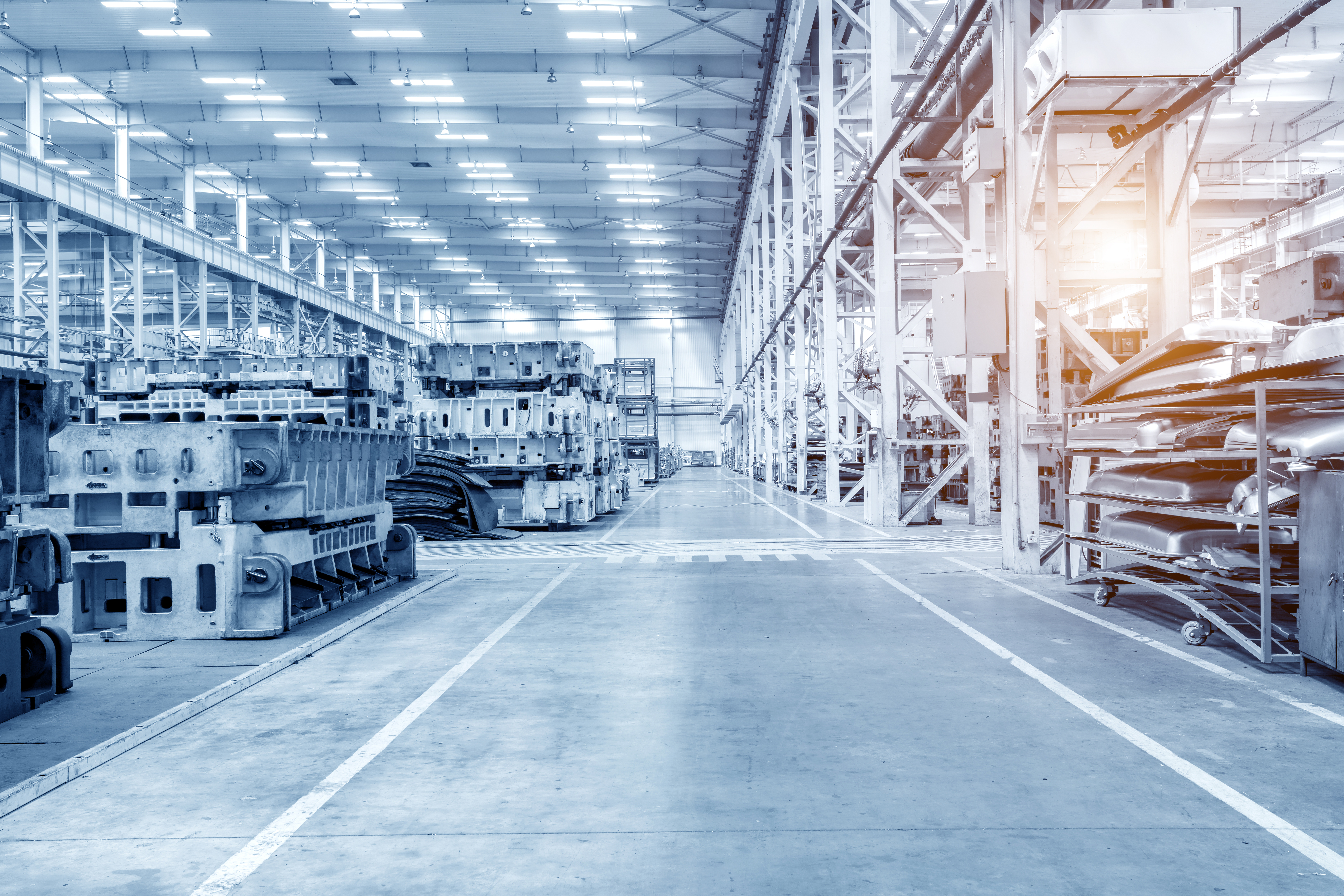 The interior of a big industrial building or factory with steel constr